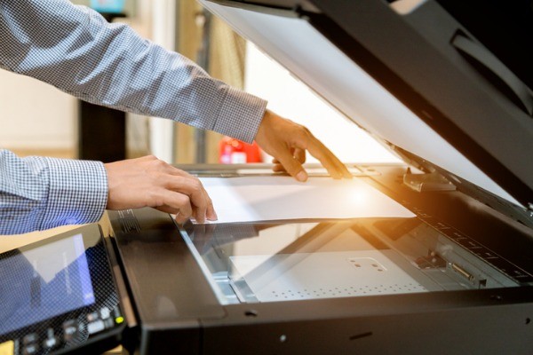 business man hand press button on panel of printer printer scanner picture id1097677028 - Managed Print