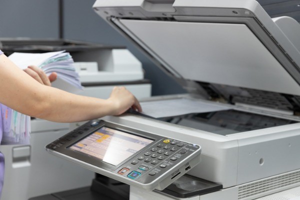 bussinesswoman using copier machine to copy heap of paperwork in picture id1153593390 - Managed Print