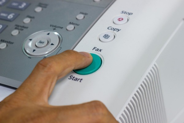 finger pressing start button on the fax picture id1001851504 - Phone Systems