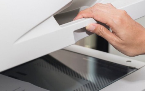 woman opening a photocopier